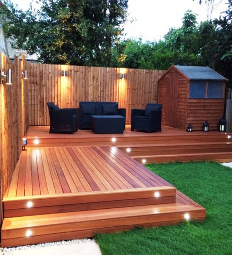 A Deck With Lighting a Black Couches